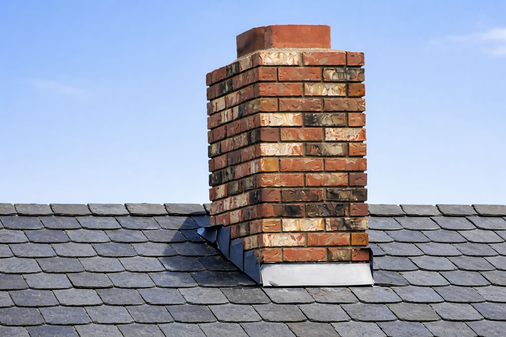 brick chimney on a natural slate roof